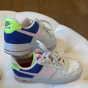 NIKE Air Force 1 in vibrant pink, red, blue, and light green.